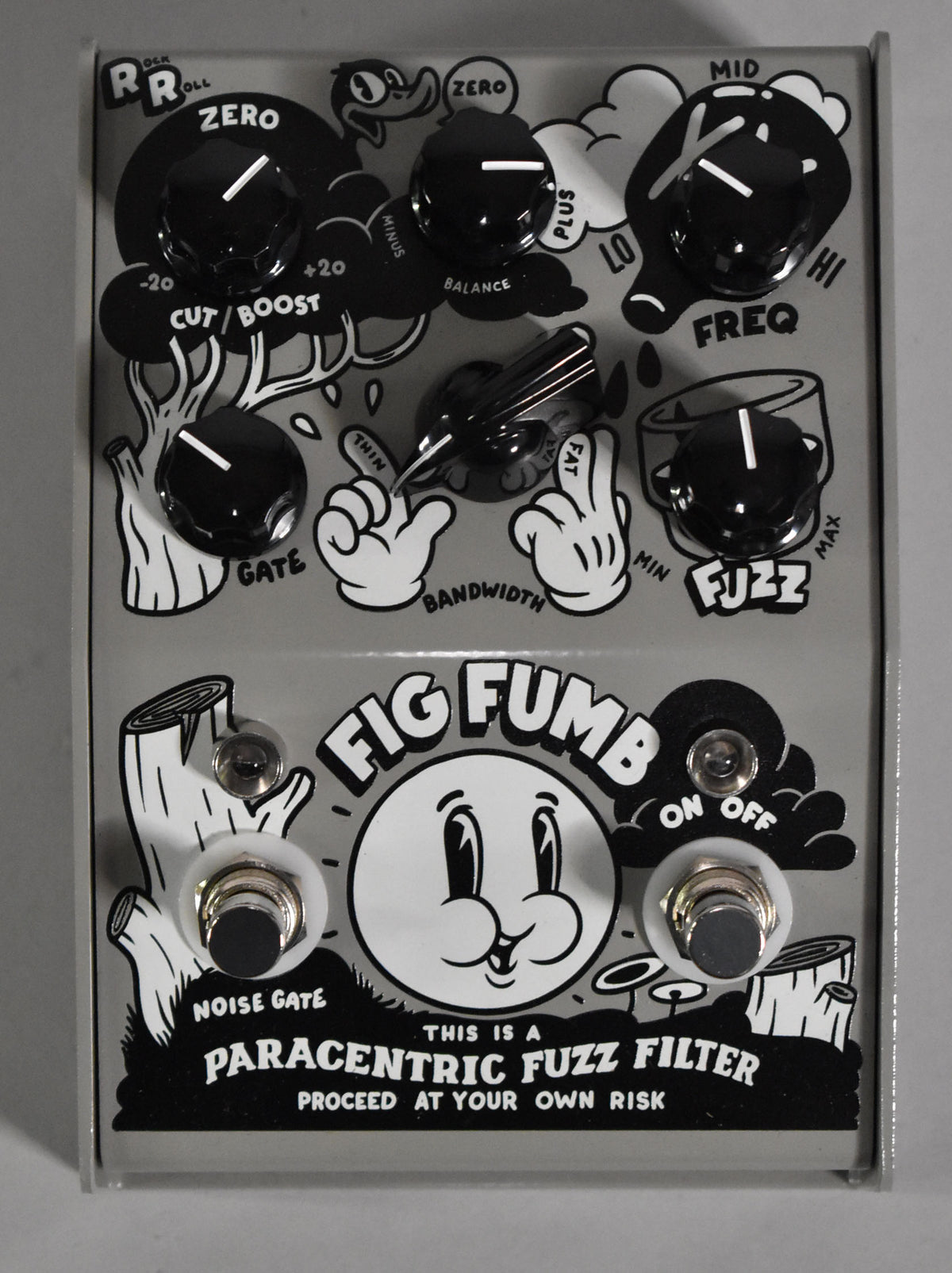 A light gray pedal with black and white cartoon graphics, seven black knobs, and two footswitches, viewed from above.