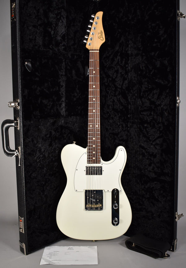 Full-length view of an Olympic White electric guitar with a humbucker and single-coil pickup, resting in a black hard case.