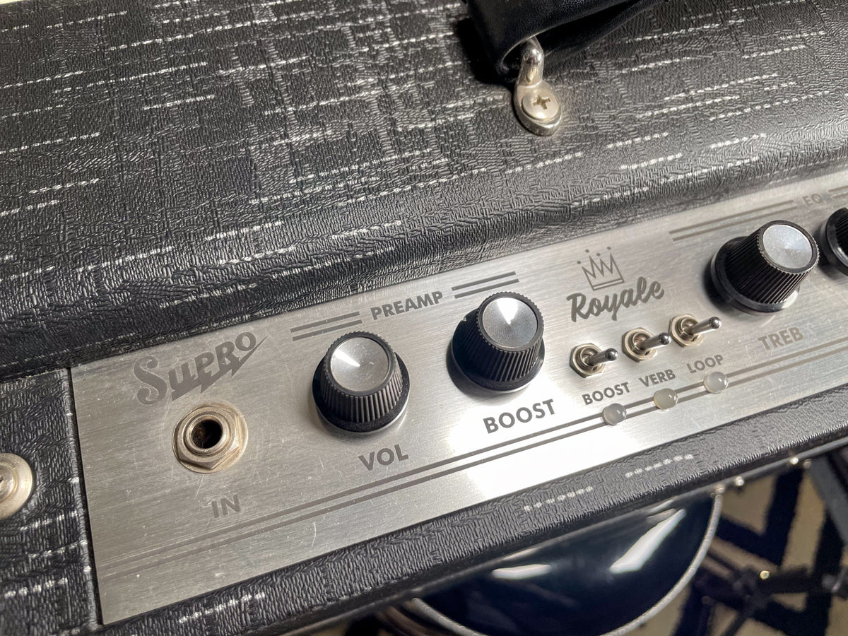 Close-up of the amp's textured black top and brushed metal control panel with silver knobs, toggle switches, and input jack.