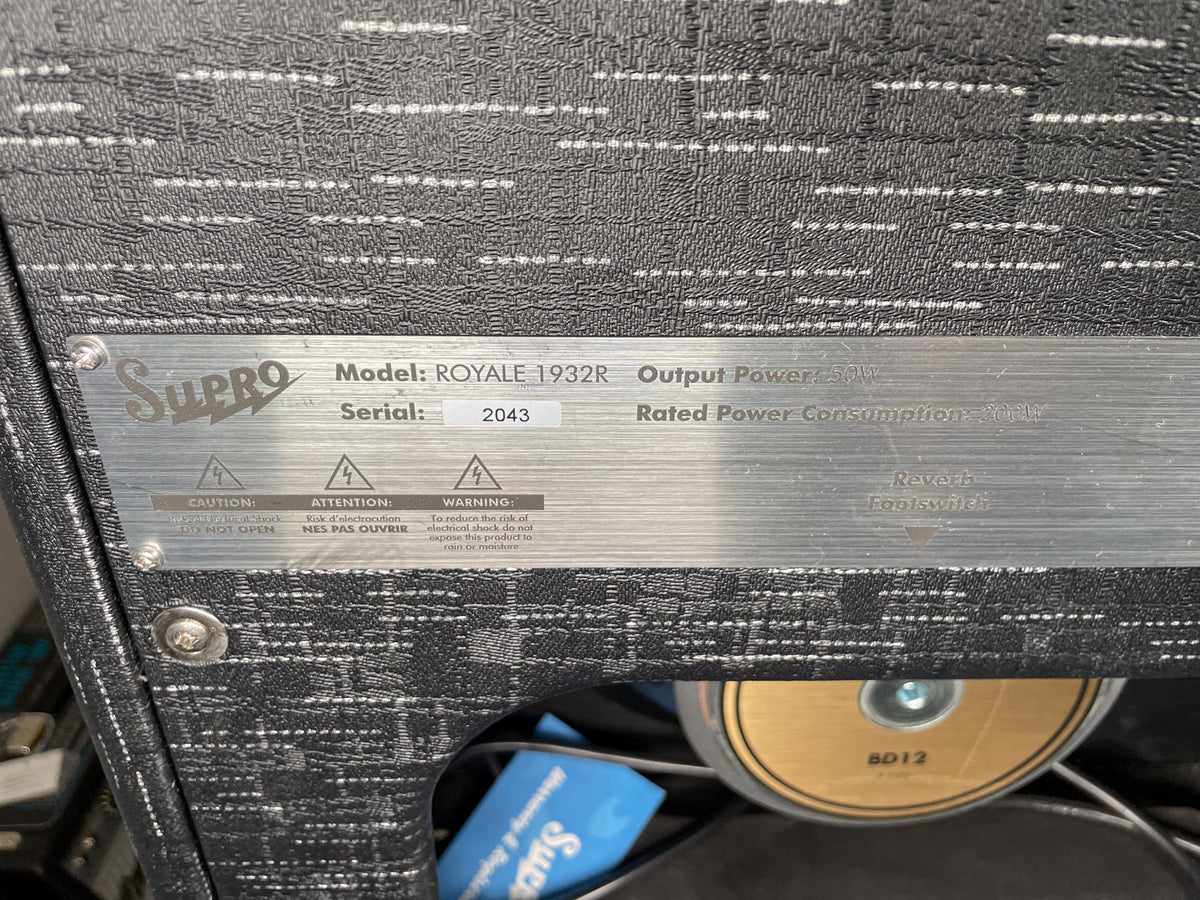 Close-up of the amp's black textured back panel with a brushed metal plate showing serial number 2043 and output power 50W.