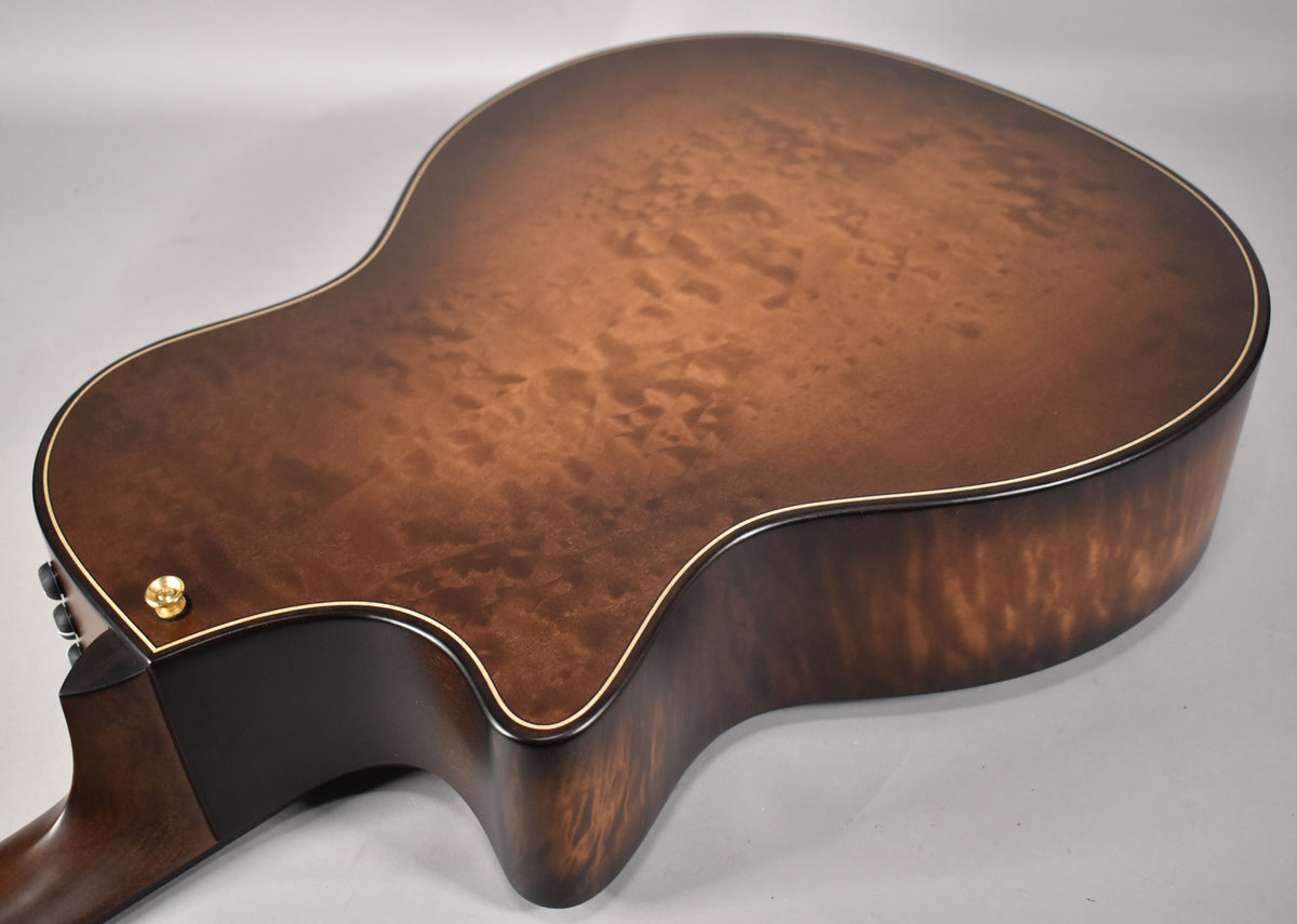 The guitar's back and side, in wild honey burst with prominent flame maple grain, are angled from the lower bout to the cutaway.