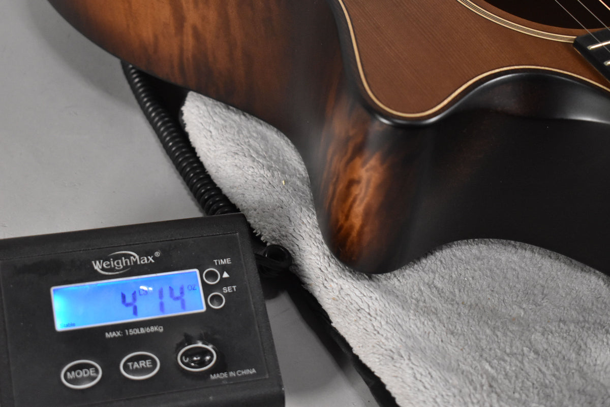 The guitar's lower bout and waist in Wild Honey Burst are shown on a scale displaying 4 lbs 14 oz.