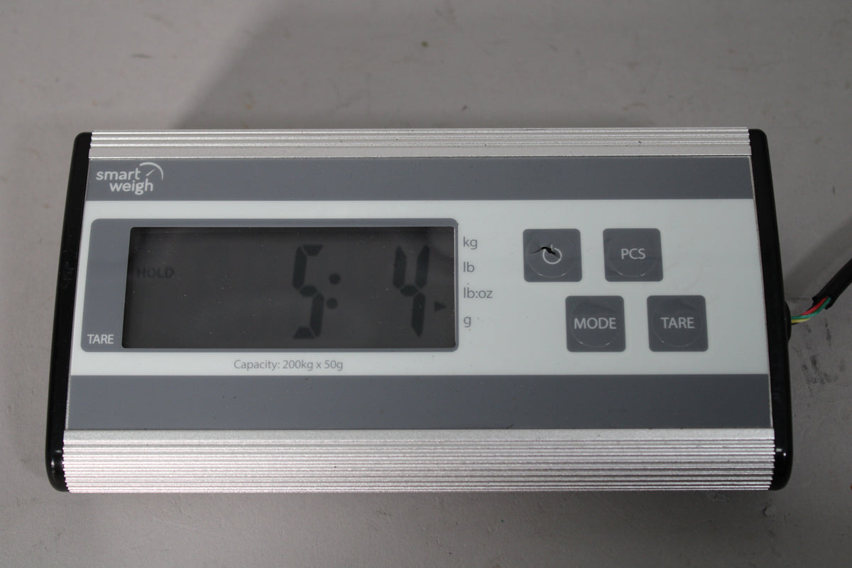 A Smart Weigh digital scale shows "5.4" on its display, with "HOLD" and "TARE" visible on the left.