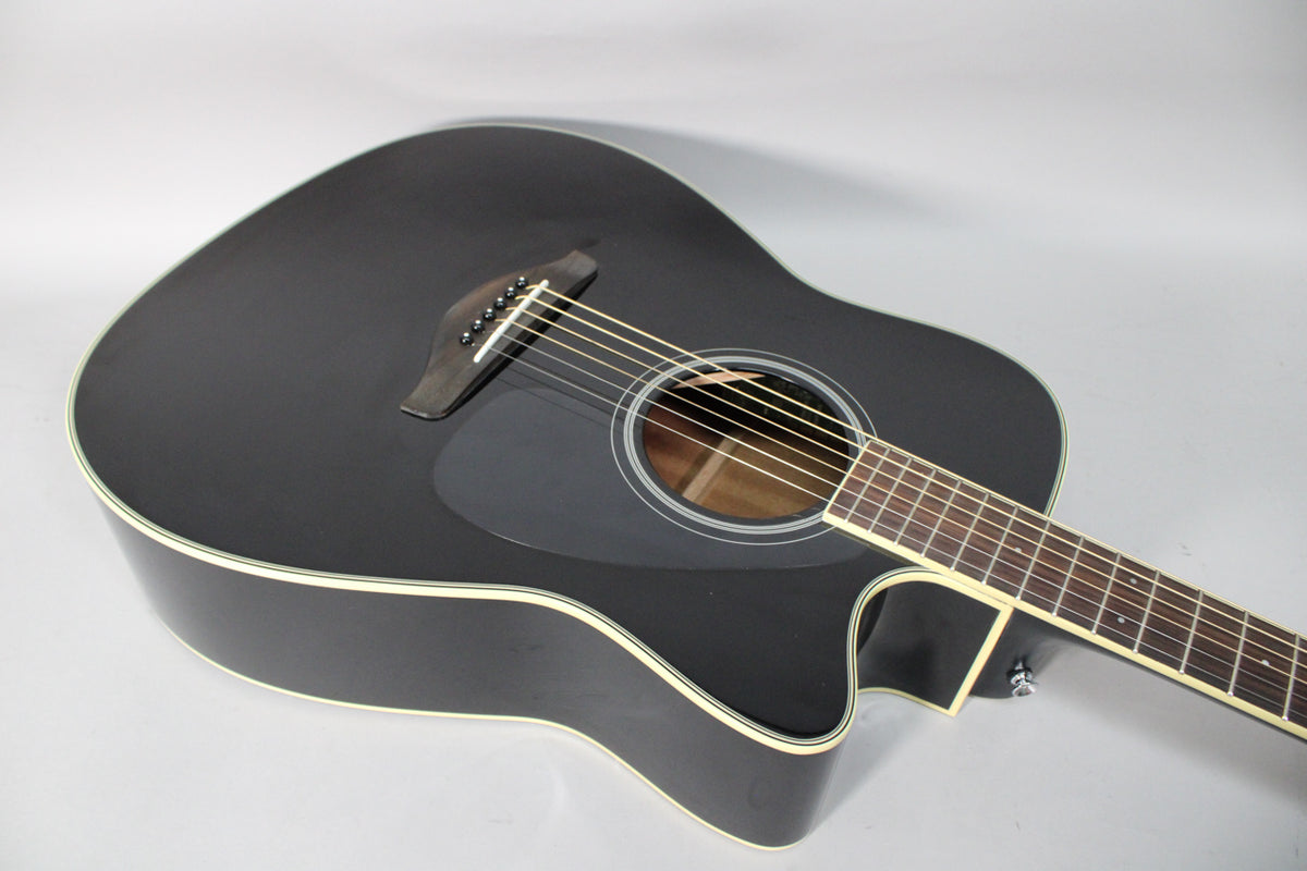 The black dreadnought acoustic-electric guitar is angled from the upper bout, showing the cutaway, soundhole, pickguard, and bridge.
