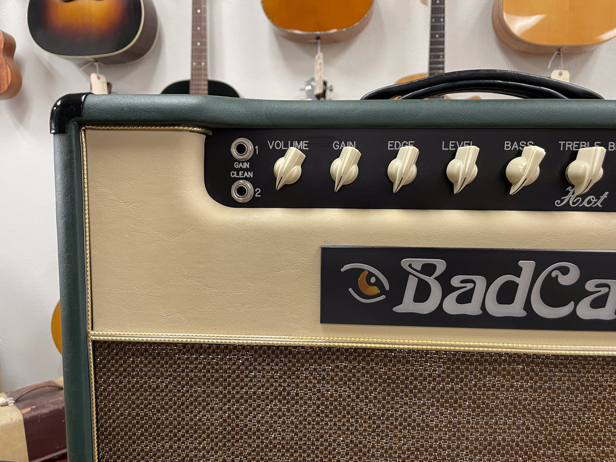 Close-up of the amp's top right, showing the dark green and cream Tolex, brown grille cloth, and cream chicken-head knobs.
