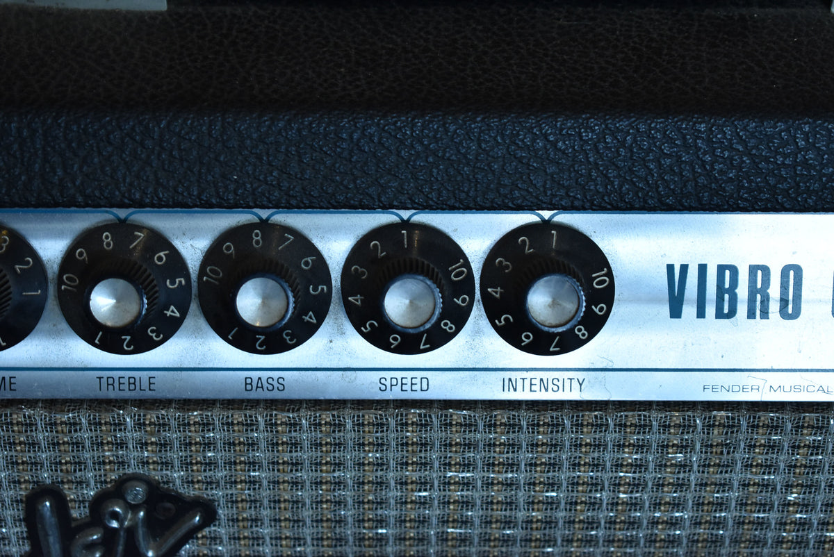 Close-up of the amp's top panel, showing four black numbered knobs for Treble, Bass, Speed, and Intensity, with some wear.