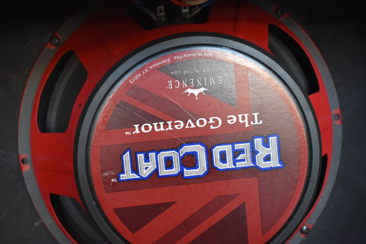 Close-up of the red speaker cone with a Union Jack design, showing some light scuffs and dust.