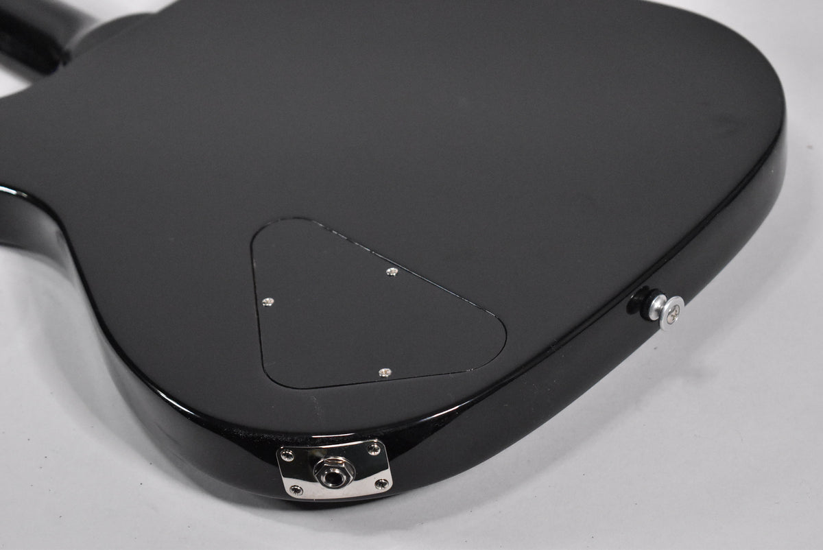 The guitar's glossy black back shows a triangular control cavity cover, a chrome output jack, and a strap button.