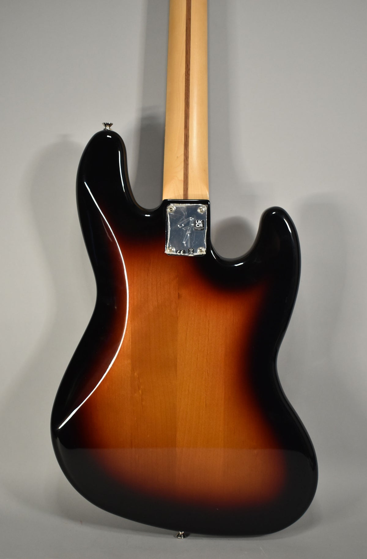 Rear view of the 3-Tone Sunburst Jazz Bass, showing the glossy finish, light wood neck, and chrome neck plate.