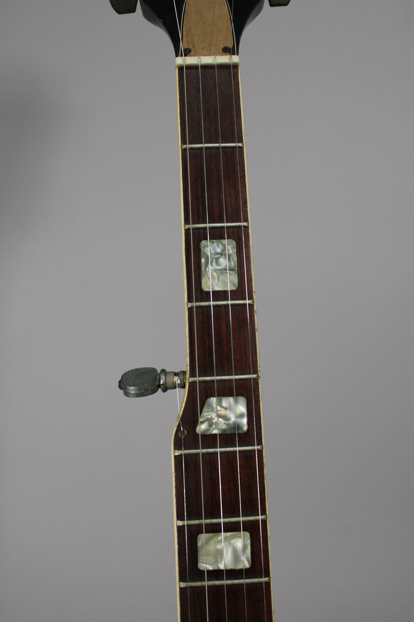 Close-up of the banjo's dark brown fretboard with rectangular mother-of-pearl inlays, showing a fifth string tuner on the side.