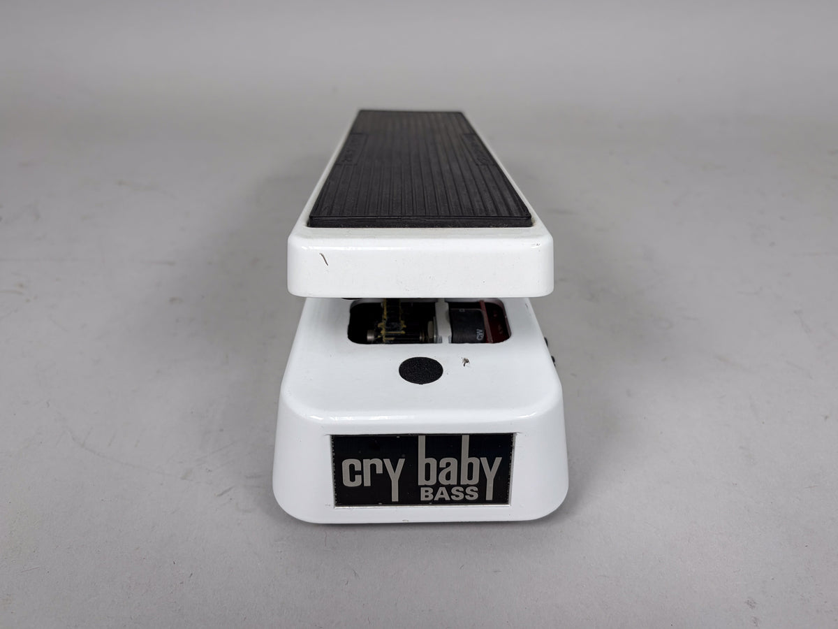 White wah pedal, viewed from the front, with a black ribbed footpad and a black circular button on the base.