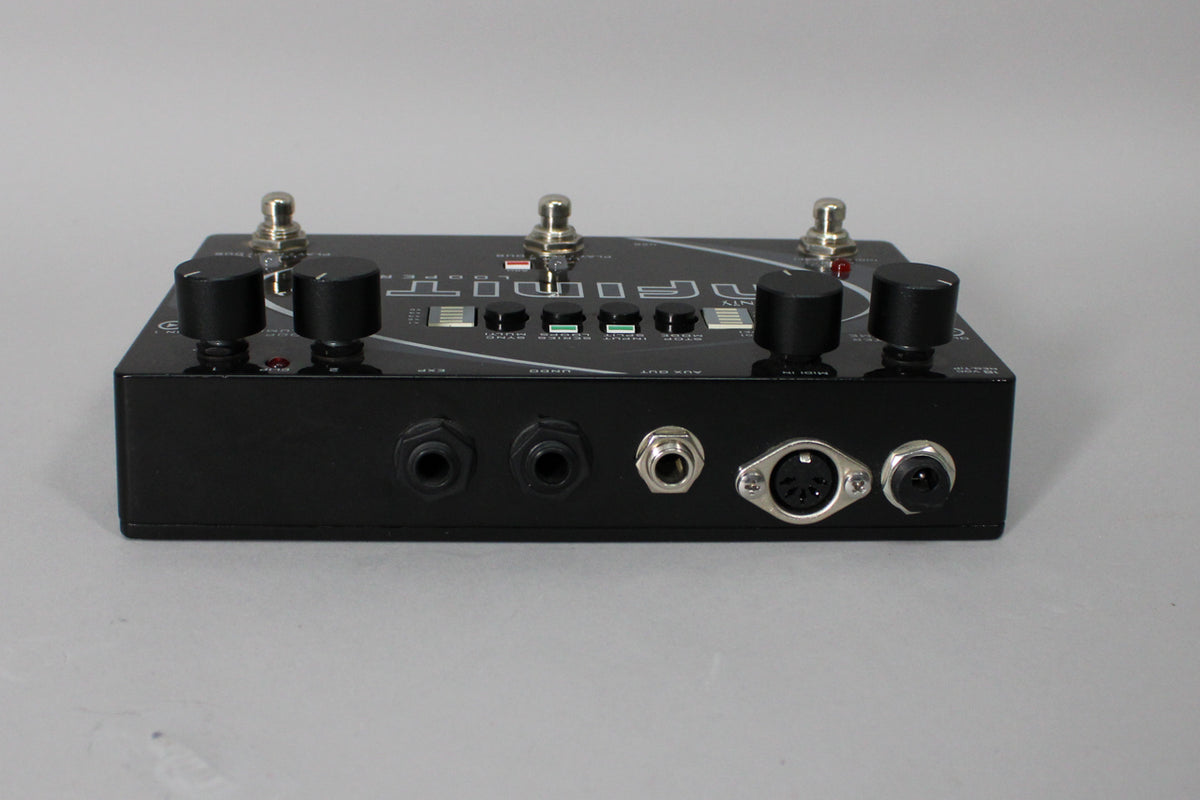 Black pedal with a glossy top, showing the rear panel with two 1/4" jacks, a smaller jack, a 5-pin MIDI port, and a power input.