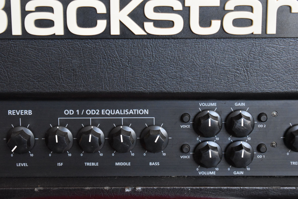 Close-up of the black textured amp head's control panel, showing reverb, OD1/OD2 equalisation, and two sets of volume/gain knobs.