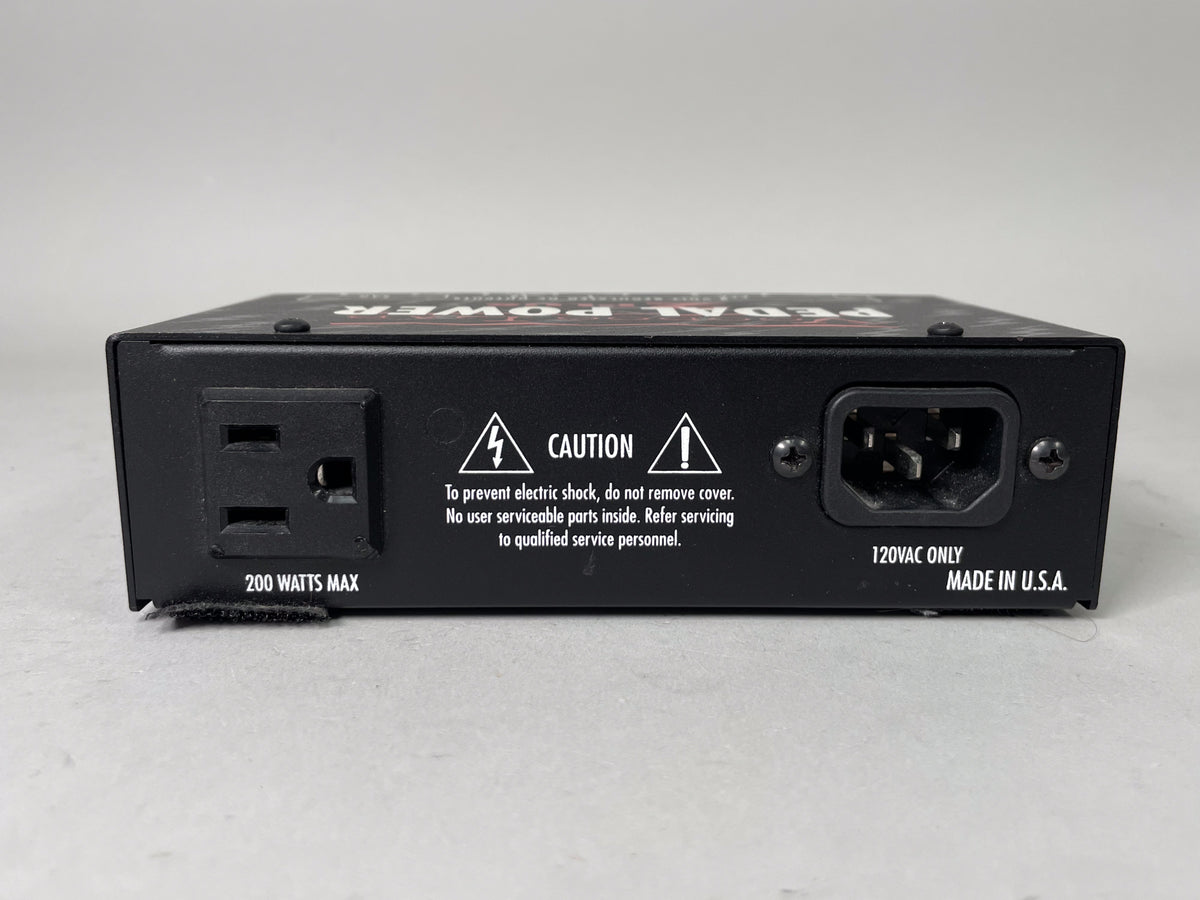 Rear view of a black Voodoo Lab Pedal Power 2 Plus with power input, output, and caution text.