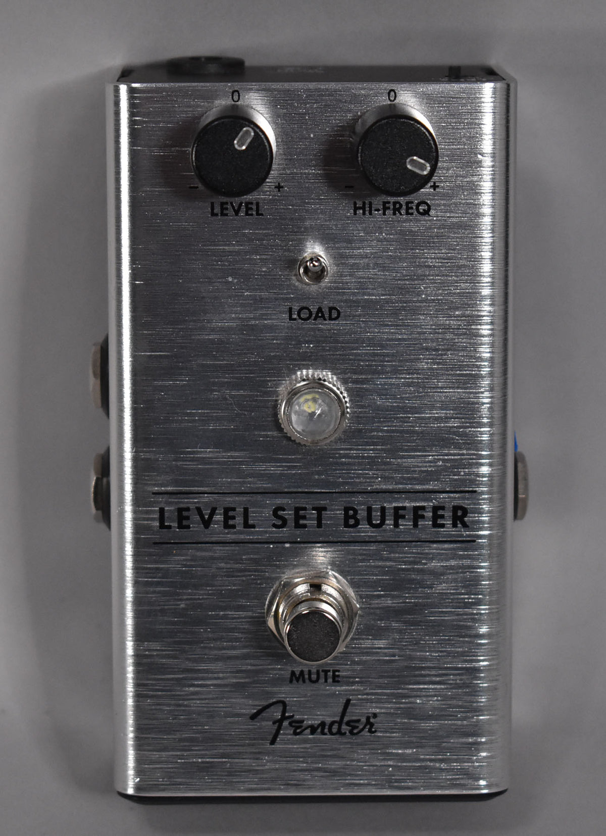 Brushed silver pedal with two black knobs, a small toggle switch, a clear LED, and a chrome footswitch.