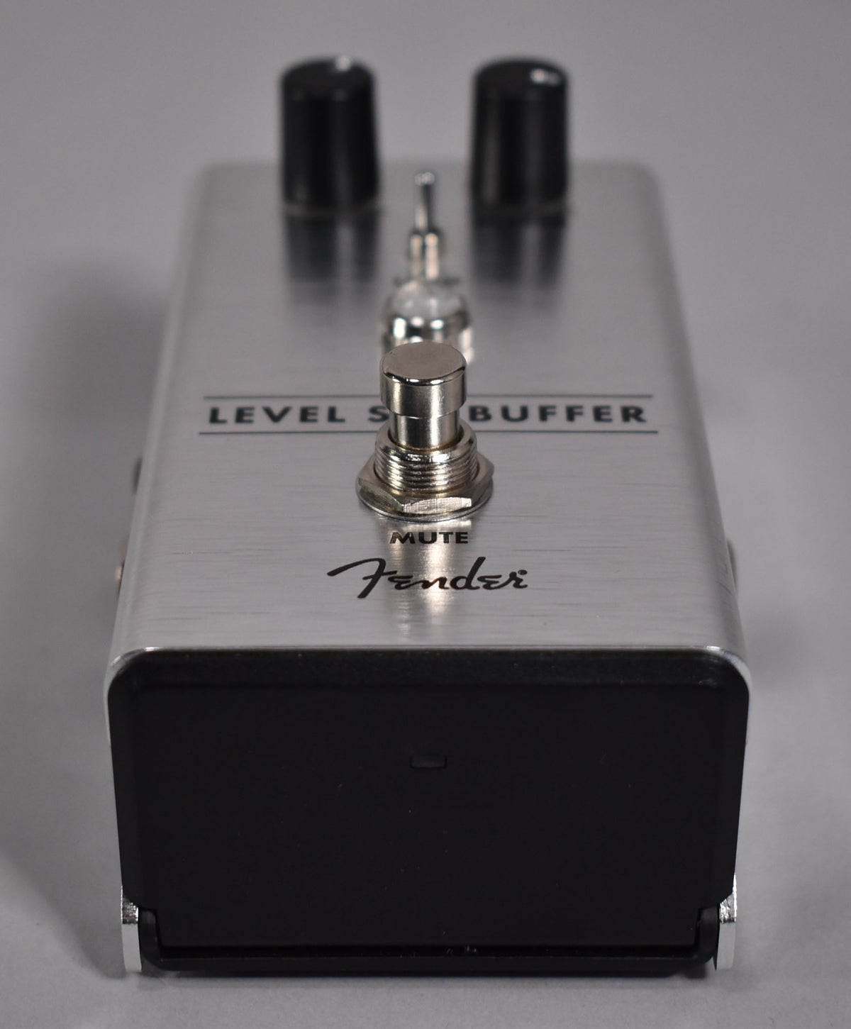 A silver brushed metal pedal, viewed from the front, with two black knobs and a chrome footswitch.