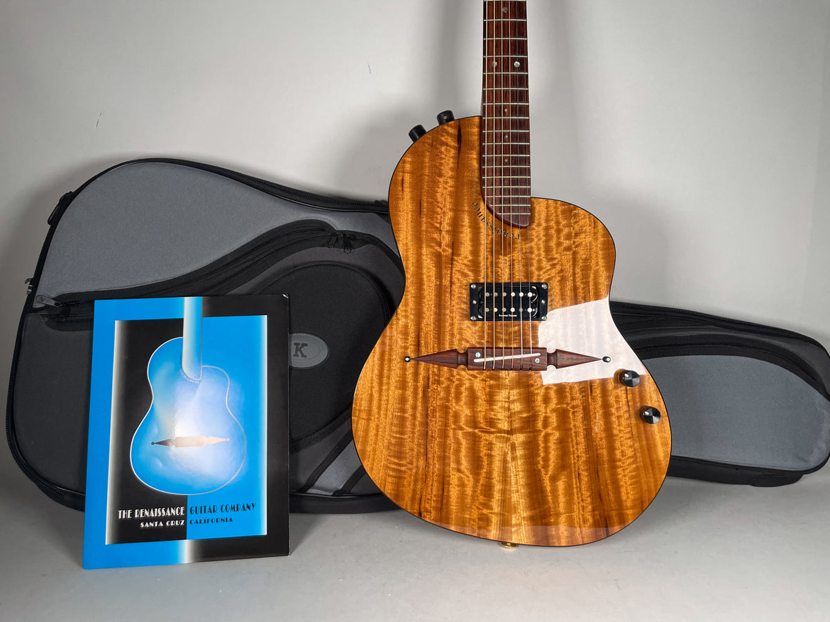 Full-body view of a glossy, amber-flamed koa guitar with a black humbucker, white pickguard, and dark wood bridge.