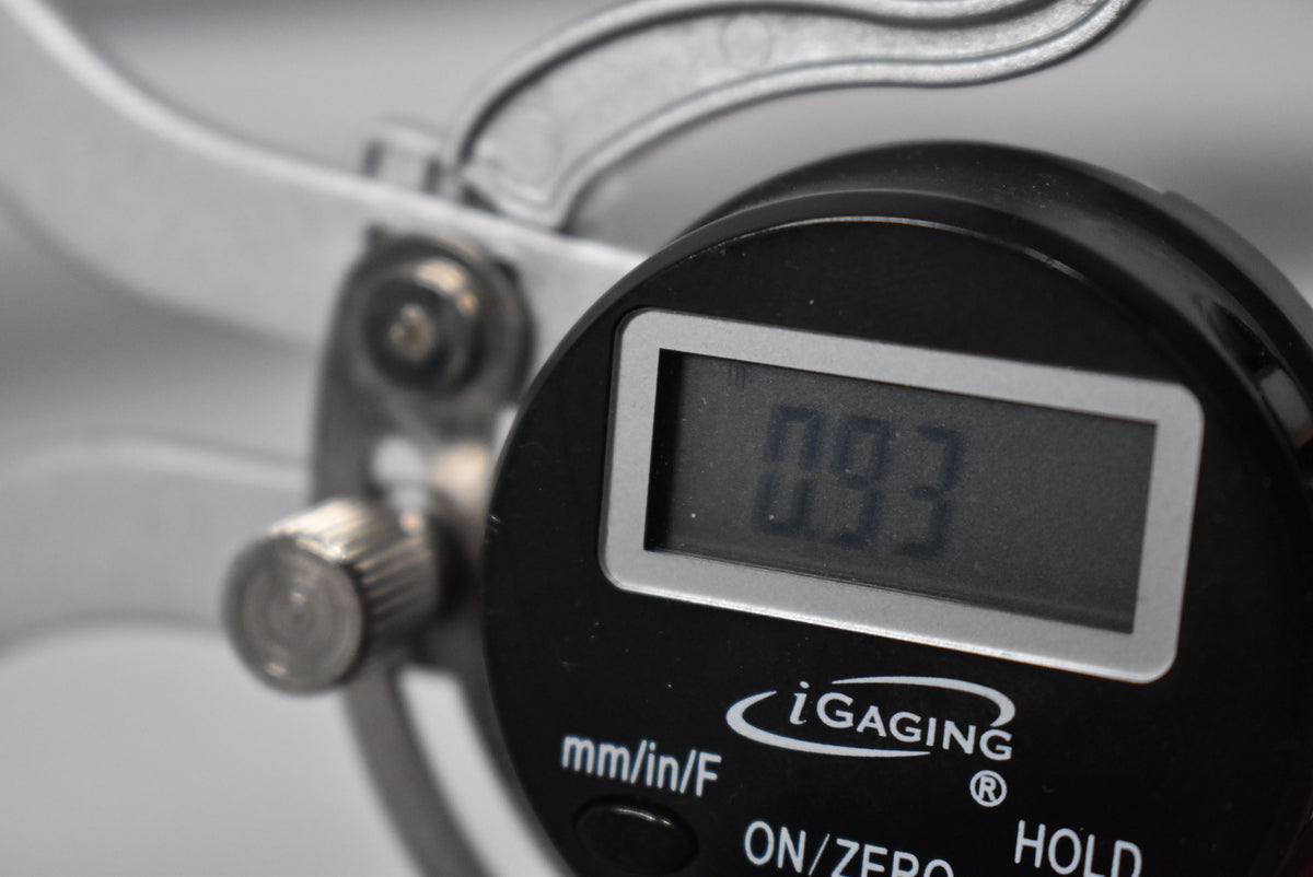 This image is not of a guitar, but a close-up of a digital caliper displaying "0.93".