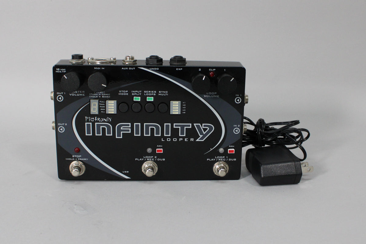 A black stereo looper pedal with three footswitches, several knobs, and an attached power adapter, viewed from the front.