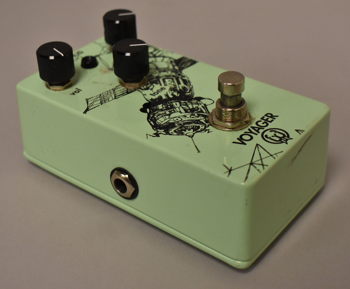 Light green pedal with black knobs, a silver footswitch, and a black line art graphic of a satellite on top, viewed from the front right.