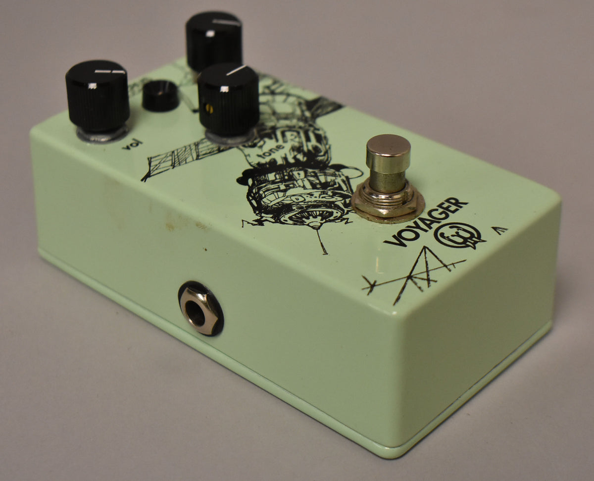 A light green pedal with black knobs and a silver footswitch, showing a black line art graphic of a satellite and some smudges.