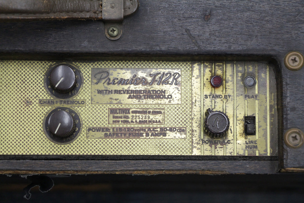 Close-up of a Premier T-12R amp's control panel, showing two "Chan 1 Tremolo" knobs, "Stand By" and "Play" lights, and a "Power A.C." knob.