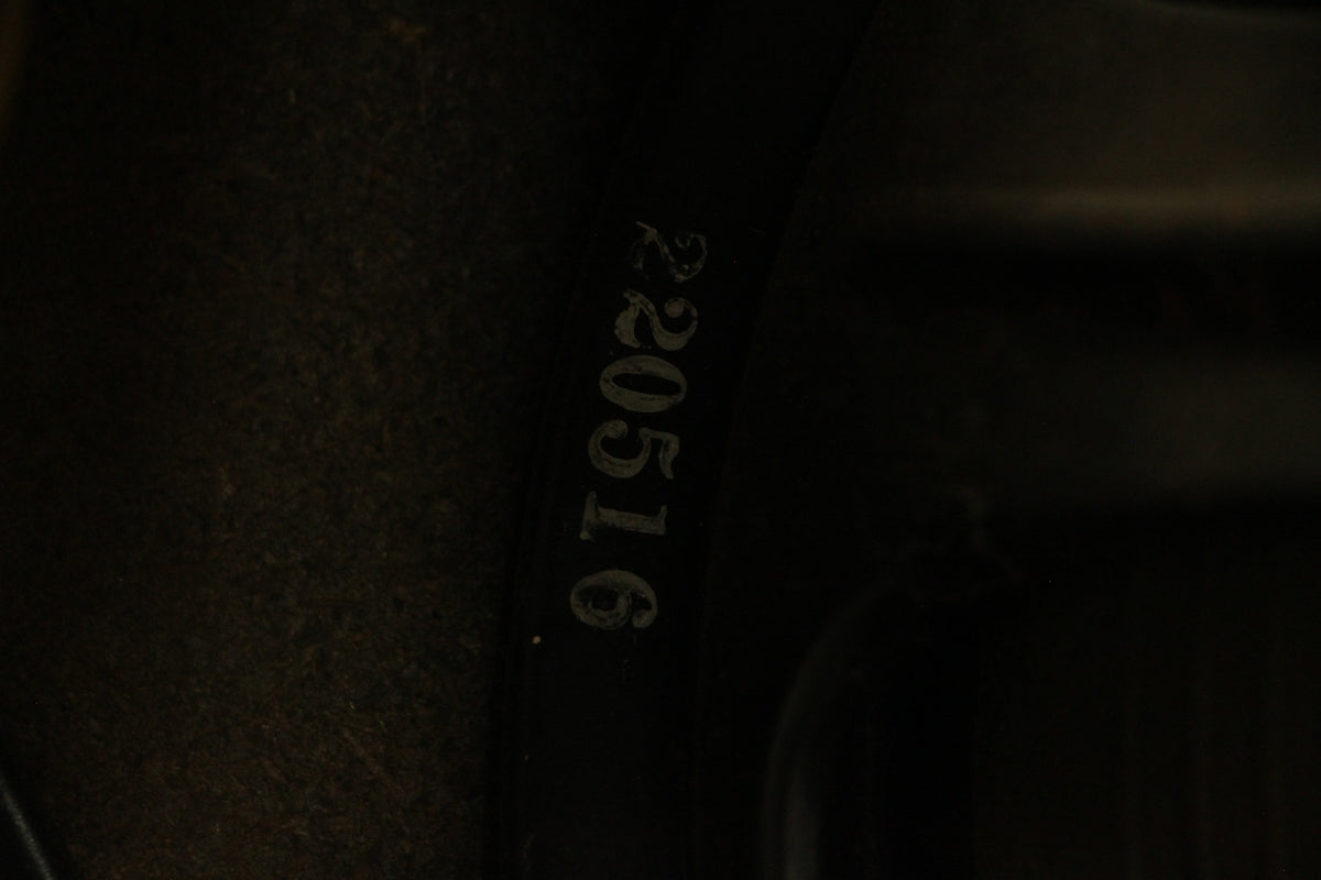 Close-up of a speaker's dark frame, with faded white numbers "220516" stamped vertically on the left side.