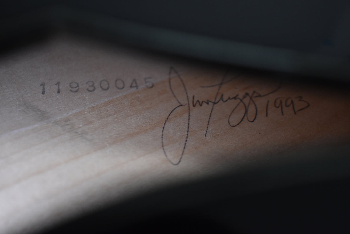 Close-up of the guitar's interior, revealing a handwritten signature and the number "1993" next to a stamped serial number "11930045".