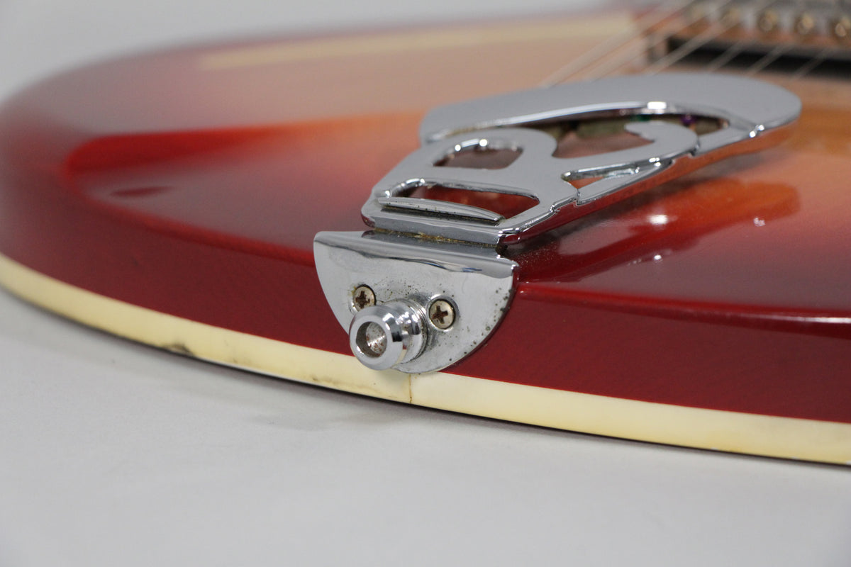 Close-up of the Fireglo body's lower bout, showing the chrome tailpiece, output jack, and light wear on the cream binding.