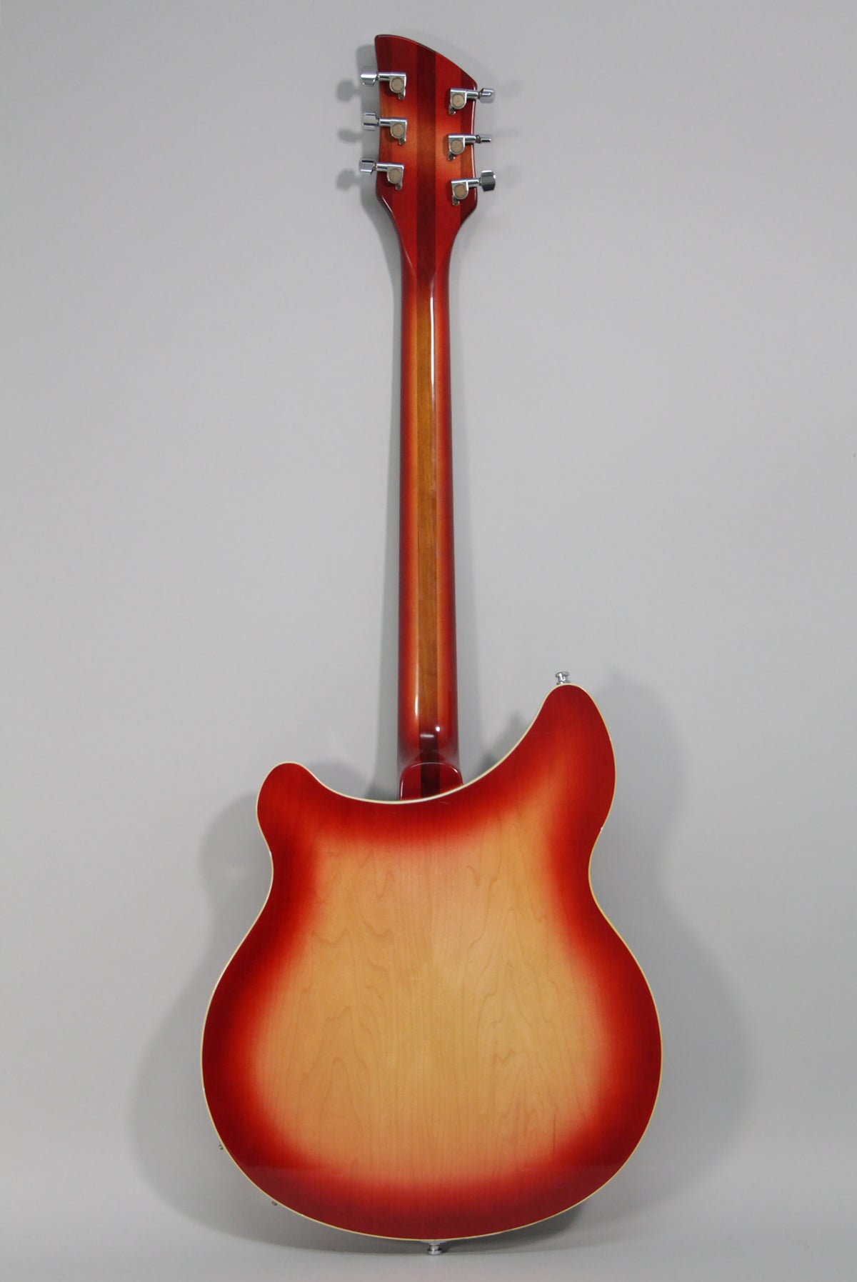 Full rear view of a Fireglo semi-hollow guitar, showing the red-to-natural sunburst finish and six chrome tuners on the headstock.