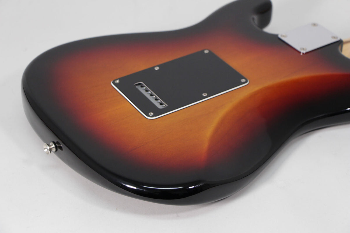 The guitar's sunburst back shows a black tremolo cover, chrome neck plate, and a strap button on the lower bout.