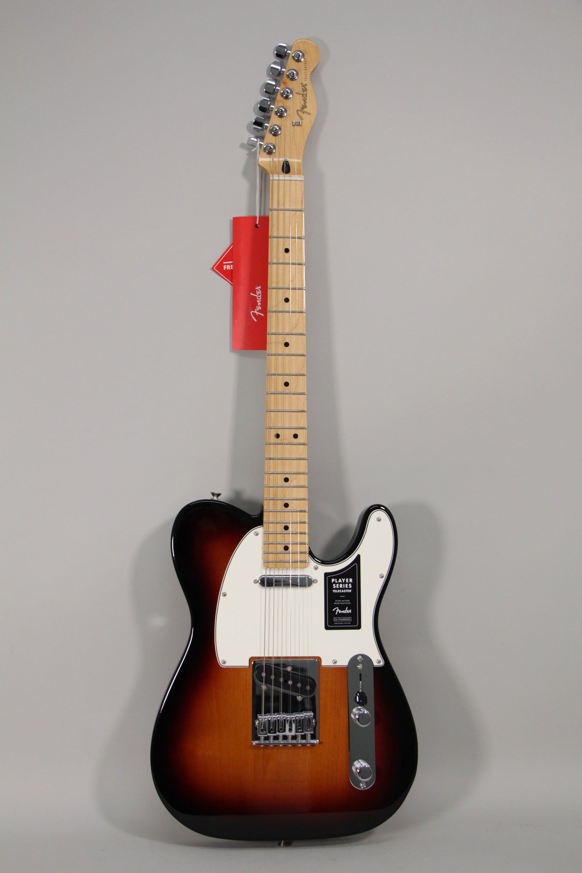Full-length view of a sunburst Telecaster with a maple neck, white pickguard, chrome hardware, and two control knobs.