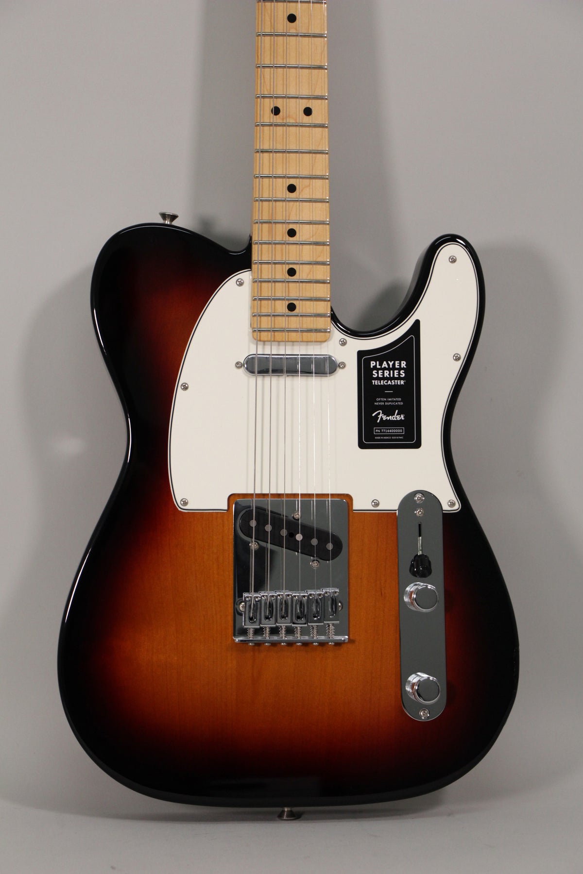 Full-front view of a sunburst Telecaster with a maple neck, white pickguard, chrome hardware, and black control knobs.