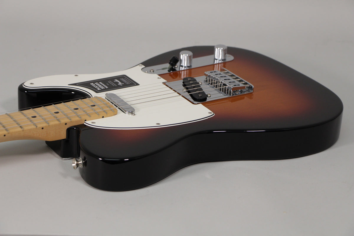 The Telecaster's sunburst body, with a white pickguard and chrome hardware, is angled from the lower bout towards the headstock.