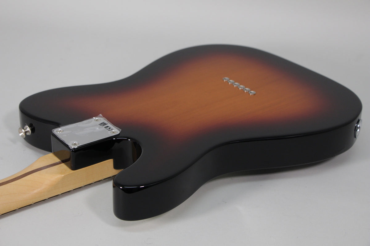 Rear view of a sunburst Telecaster body, showing the glossy finish, chrome string-through-body ferrules, and neck plate.