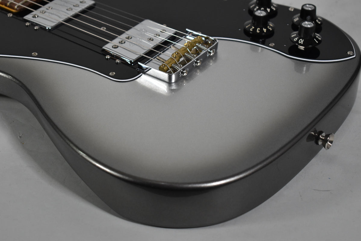 Upper body of a Telecaster Deluxe in Mercury finish, showing the black pickguard, chrome humbuckers, bridge, and control knobs.