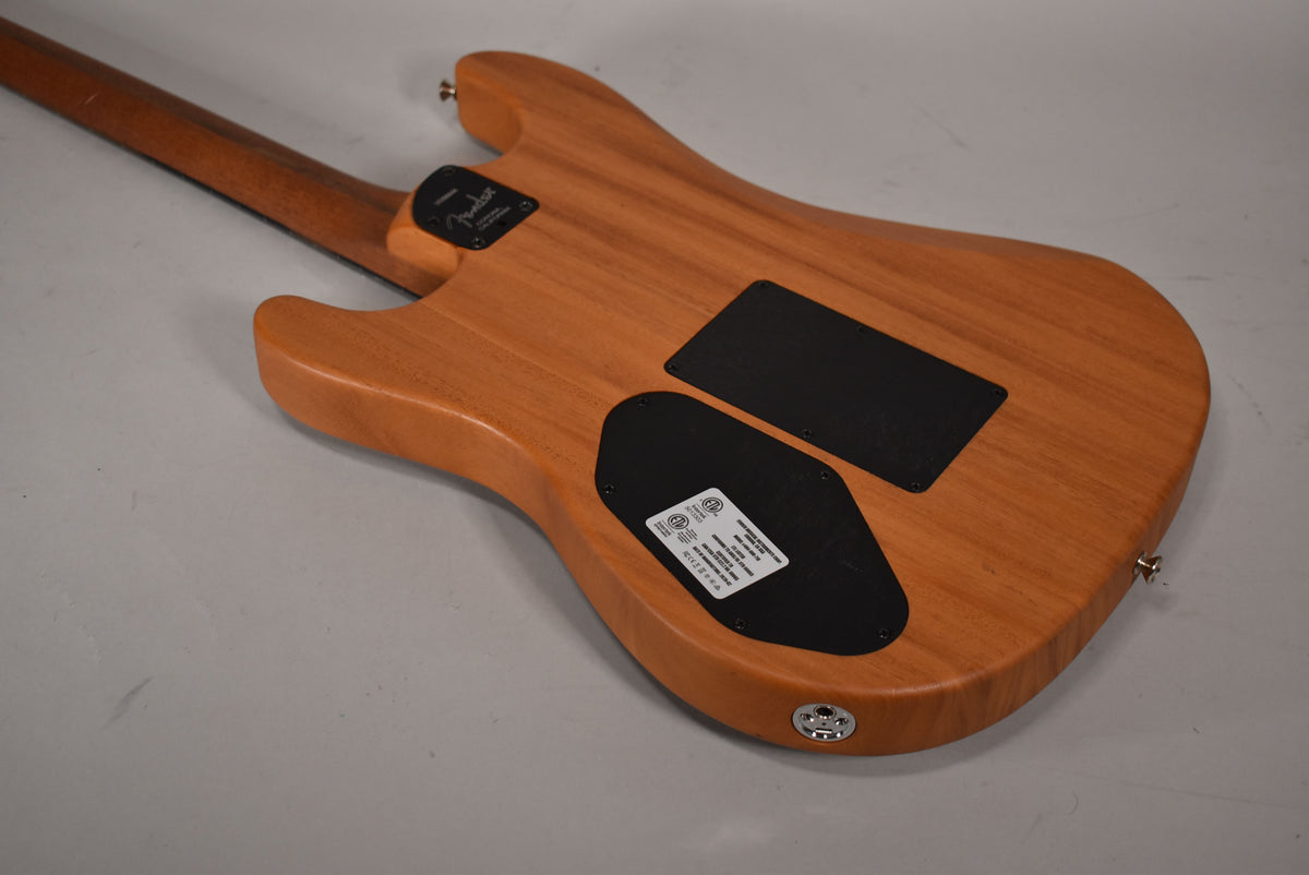 The guitar's back, in a natural wood finish, shows two black control plates and a chrome output jack.