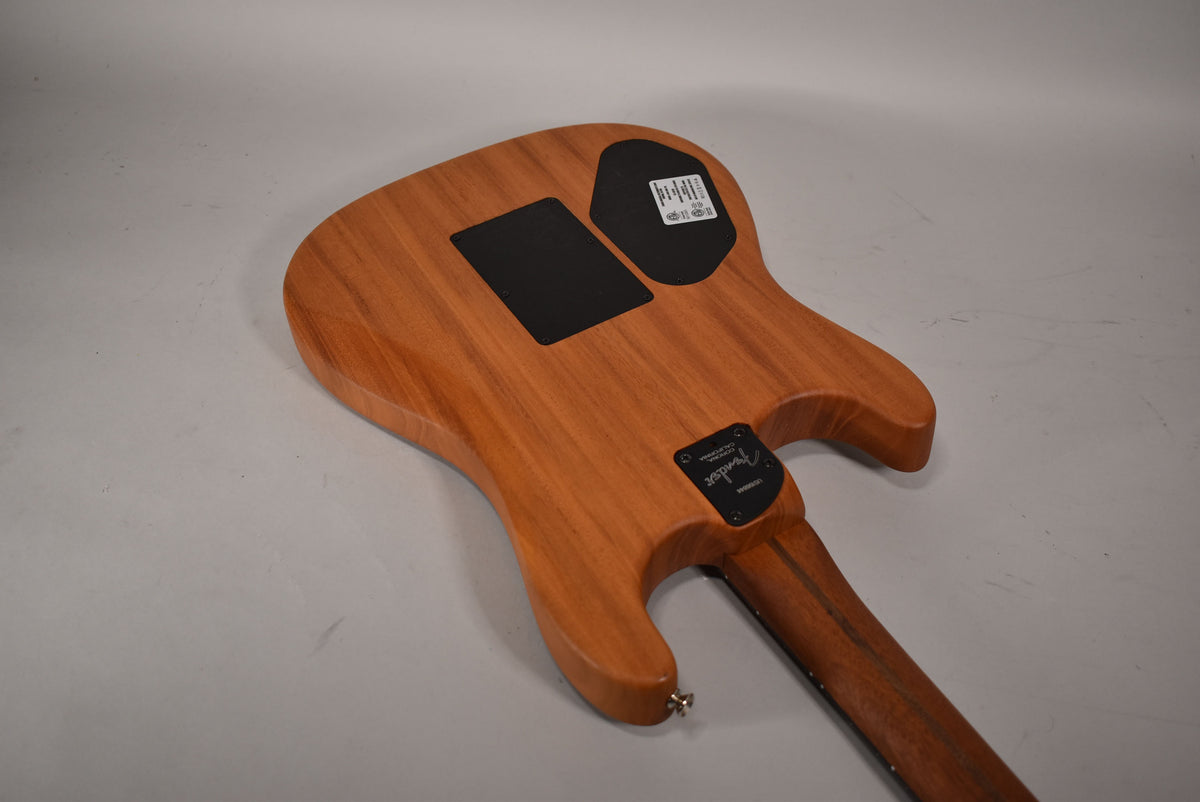 The guitar's back, in natural wood grain, shows two black control plates and a black neck plate with a silver strap button.