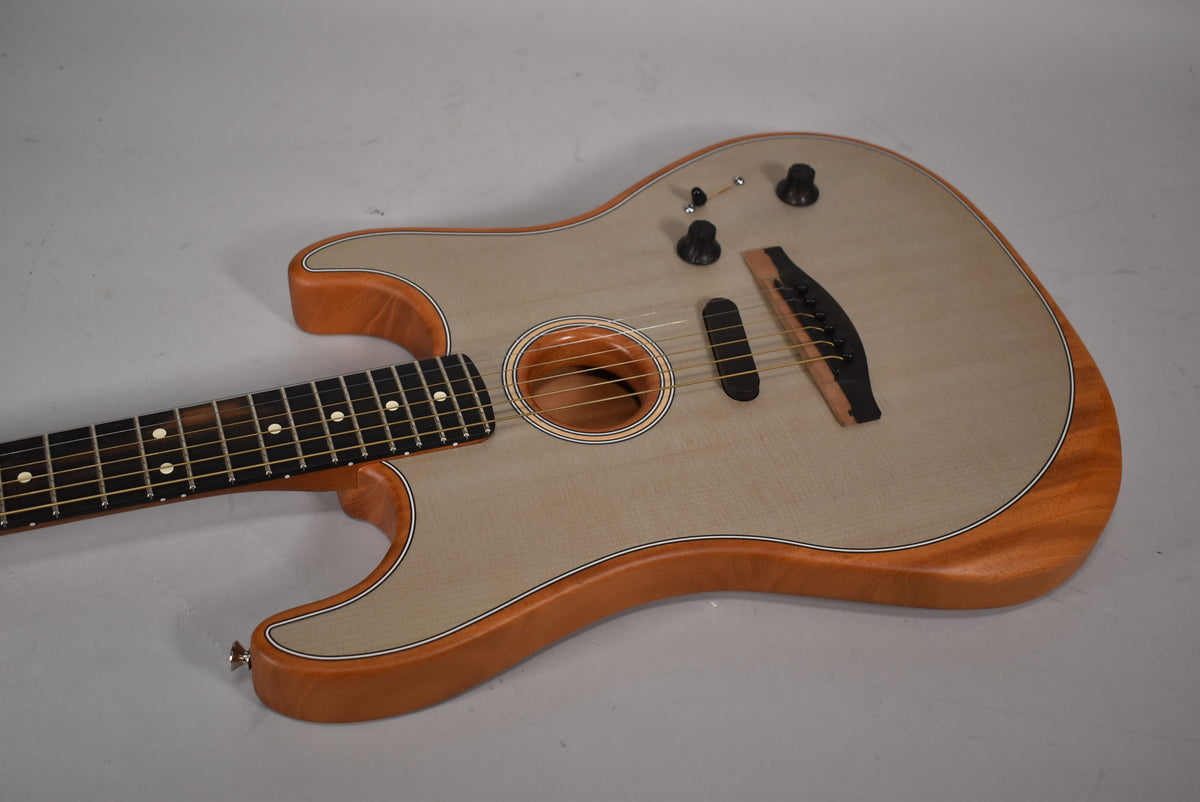 Acoustic guitar with a light wood body, dark fretboard, soundhole, bridge, and three black control knobs.