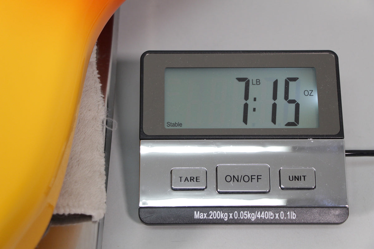 The guitar's Tequila Sunrise body rests on a scale displaying its weight as 7 pounds, 15 ounces.