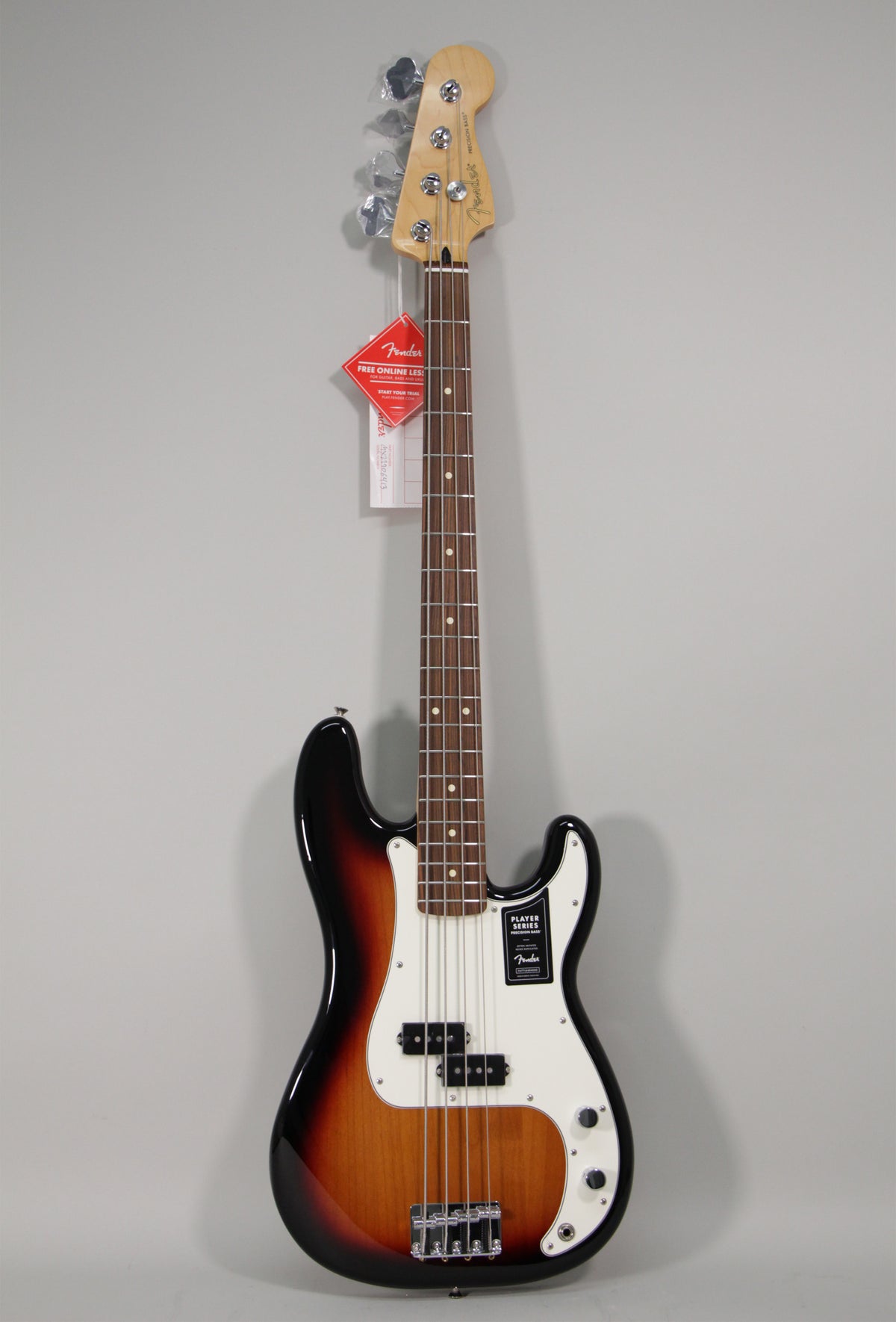 Full-length view of a new Precision Bass with a glossy sunburst finish, white pickguard, split-coil pickup, and chrome hardware.