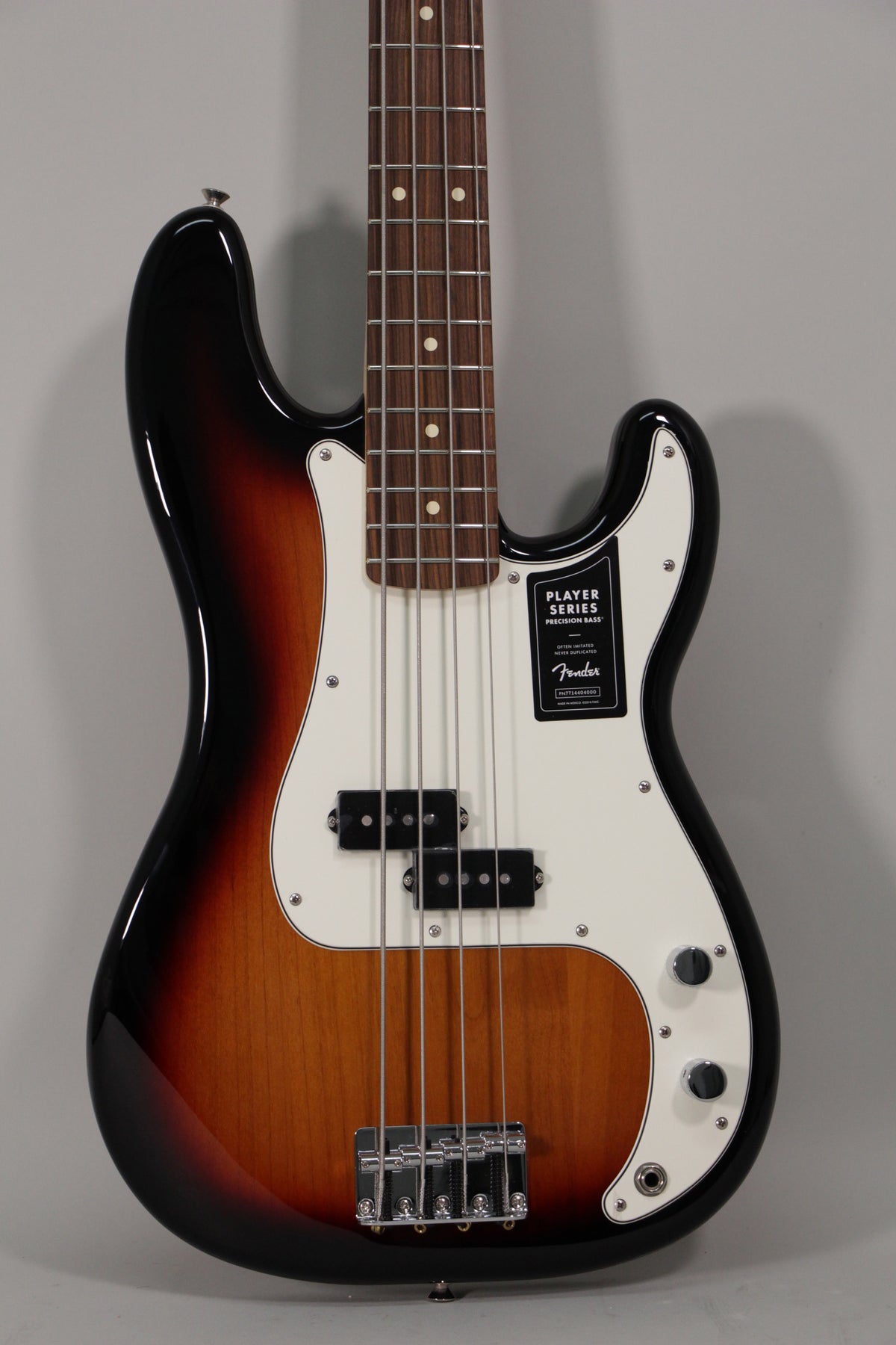 Full-frame, glossy sunburst Precision Bass with a white pickguard, split pickup, chrome bridge, and two control knobs.