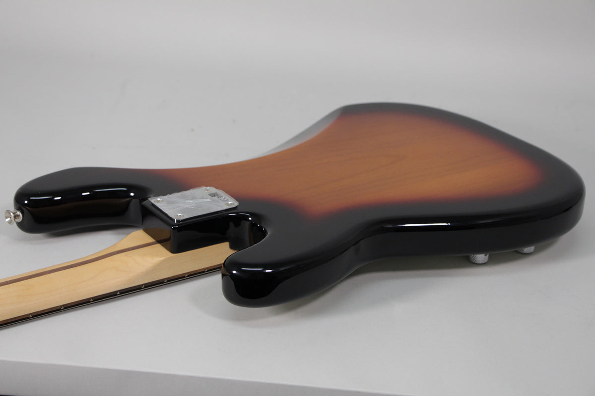 The bass body's sunburst finish transitions from dark brown to light brown, with a chrome neck plate and strap buttons.