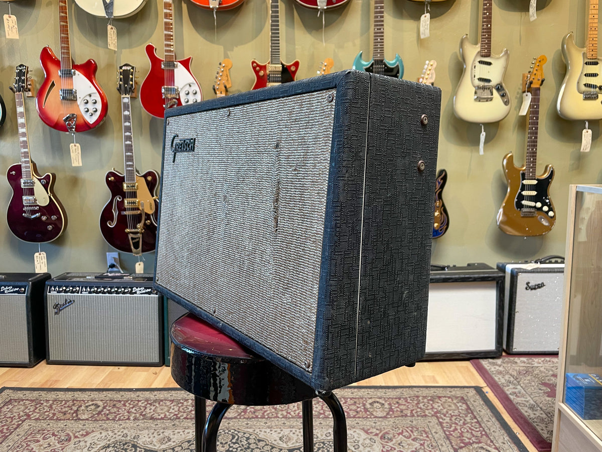 Black textured combo amp with a silver grille, viewed from the front-right, showing some wear and a small logo on the grille.