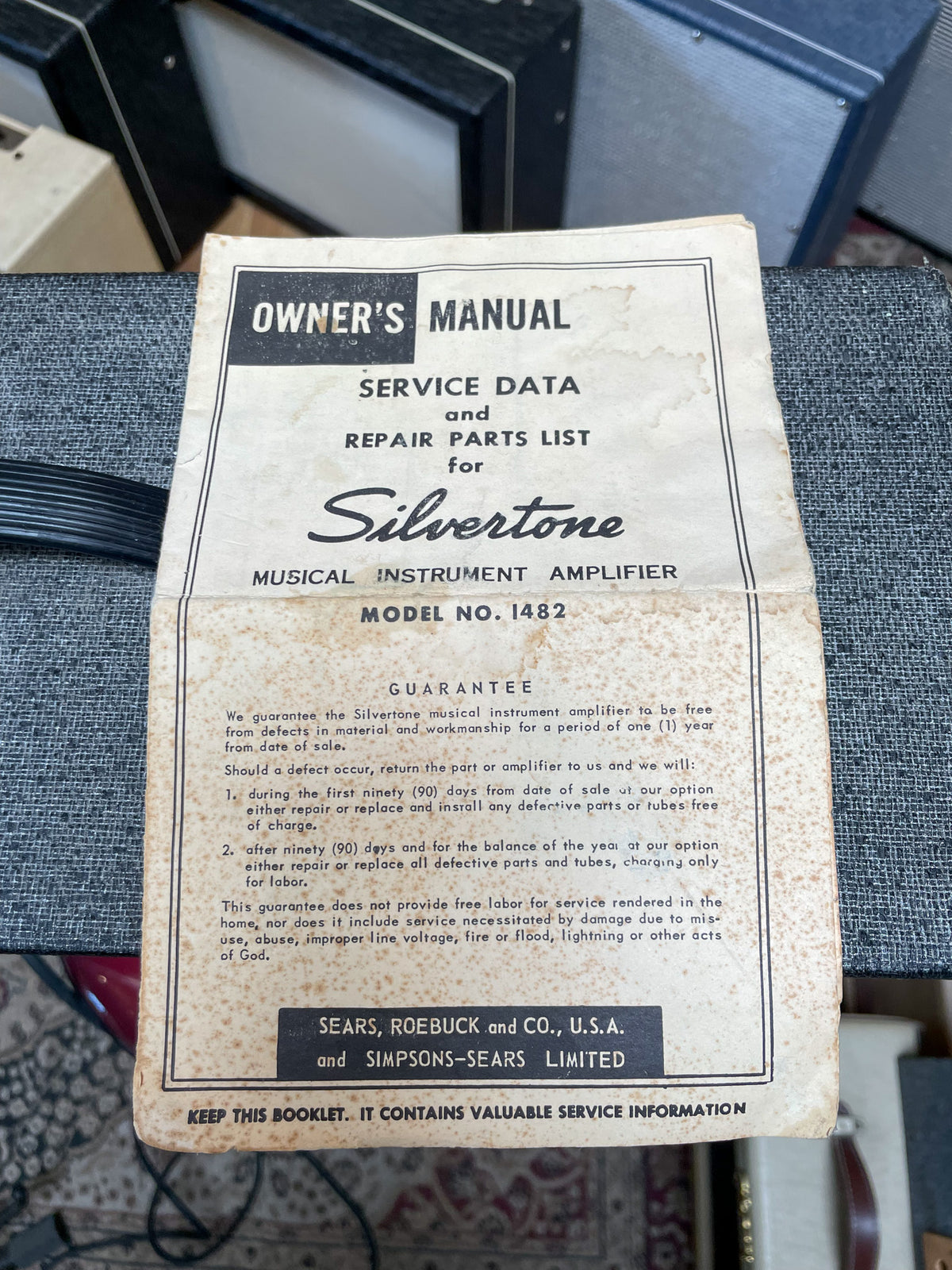 A top-down view of the amp's original, discolored owner's manual, showing its cover with "OWNER'S MANUAL" and "MODEL NO. 1482".