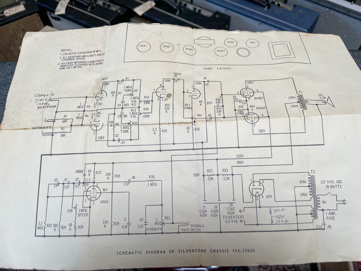 A white paper schematic diagram for the amp chassis, showing tube layout, components, and voltages, with visible creases.