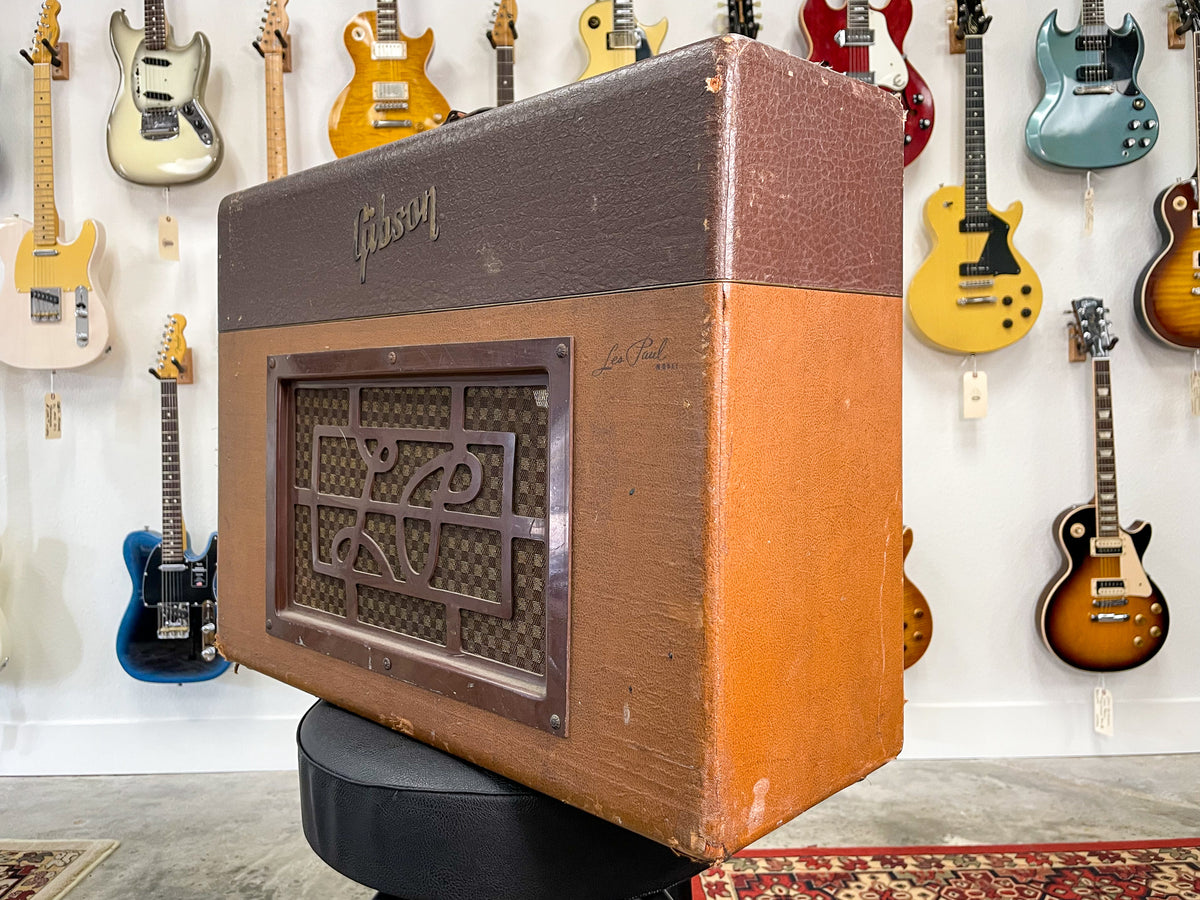A vintage combo amp, angled to show its brown textured top and tan sides with a decorative brown grille and visible wear.