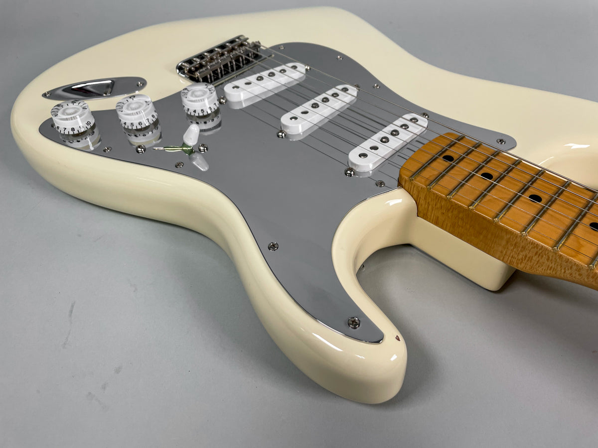 Olympic white Stratocaster body with a grey pickguard, three single-coil pickups, chrome hardware, and a maple fretboard.