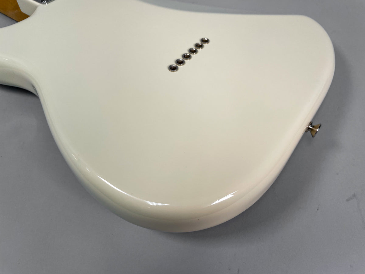 The back of the Olympic White Stratocaster body, showing six string-through-body ferrules and the lower strap button.