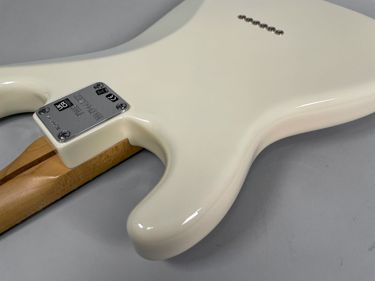 Close-up of the guitar's Olympic White body, showing the neck plate, neck heel, and six string ferrules on the back.